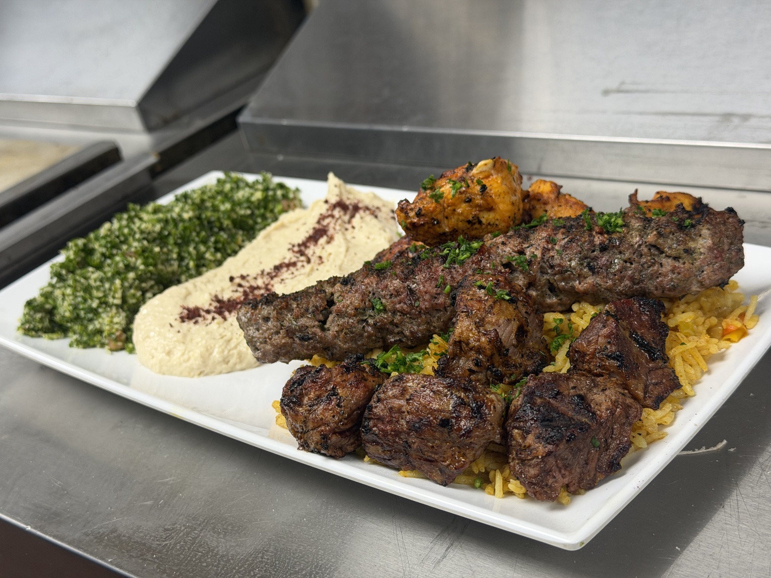 Sharbecue grilled meat platter with rice, hummus and tabbouleh